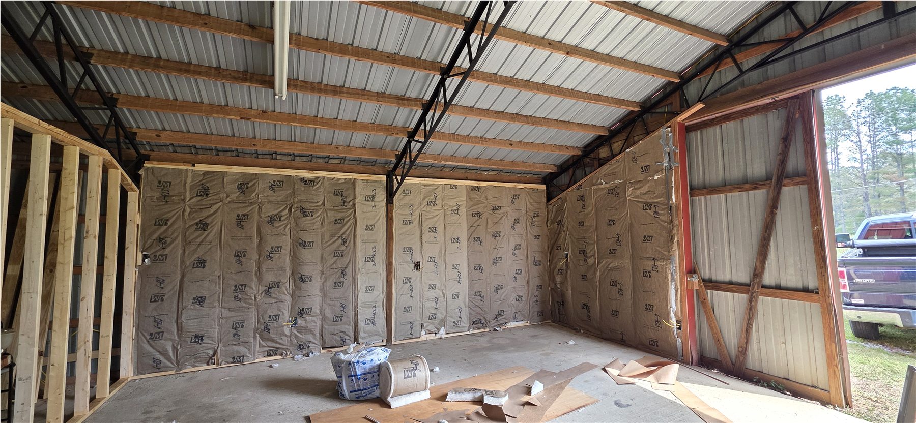 Insulation work begins inside the barn