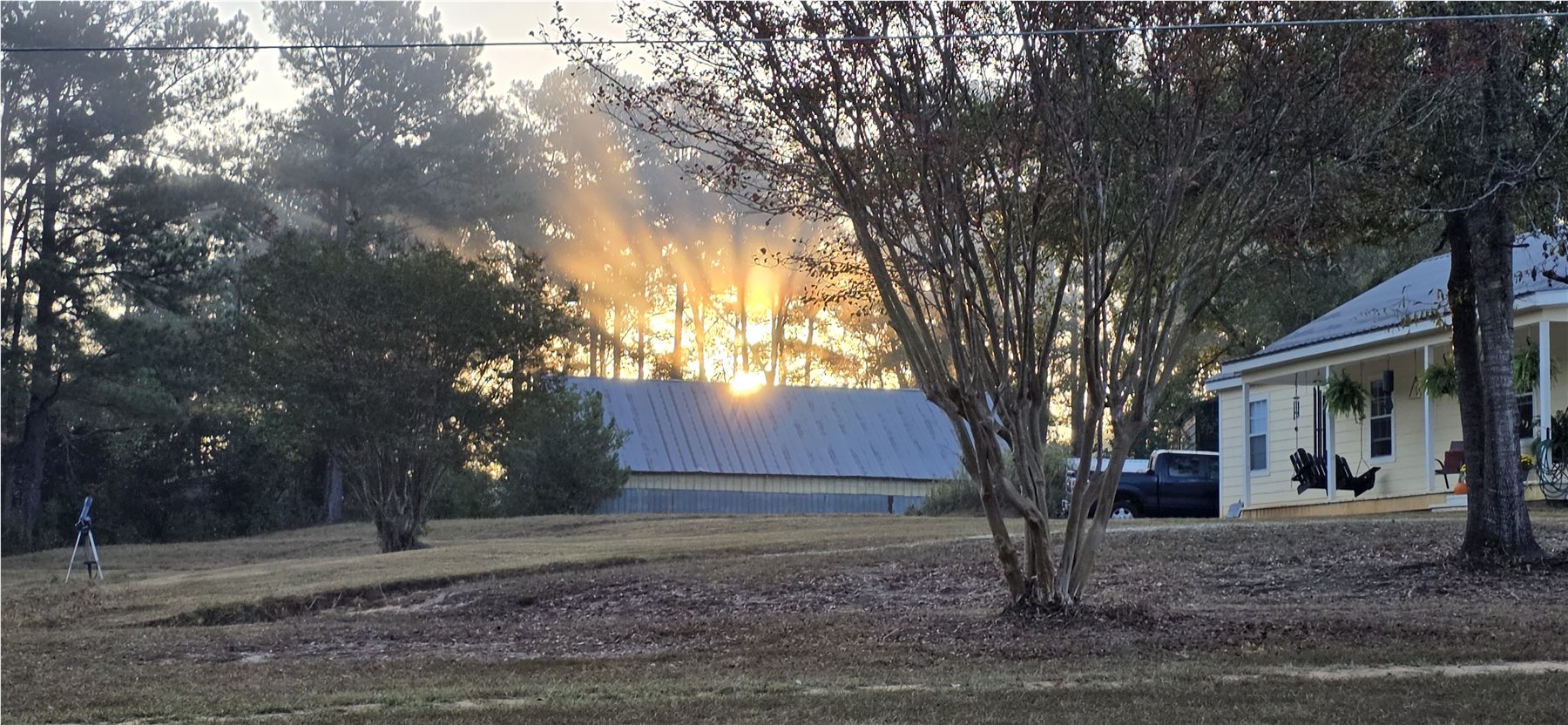 Sunrise over the house and barn