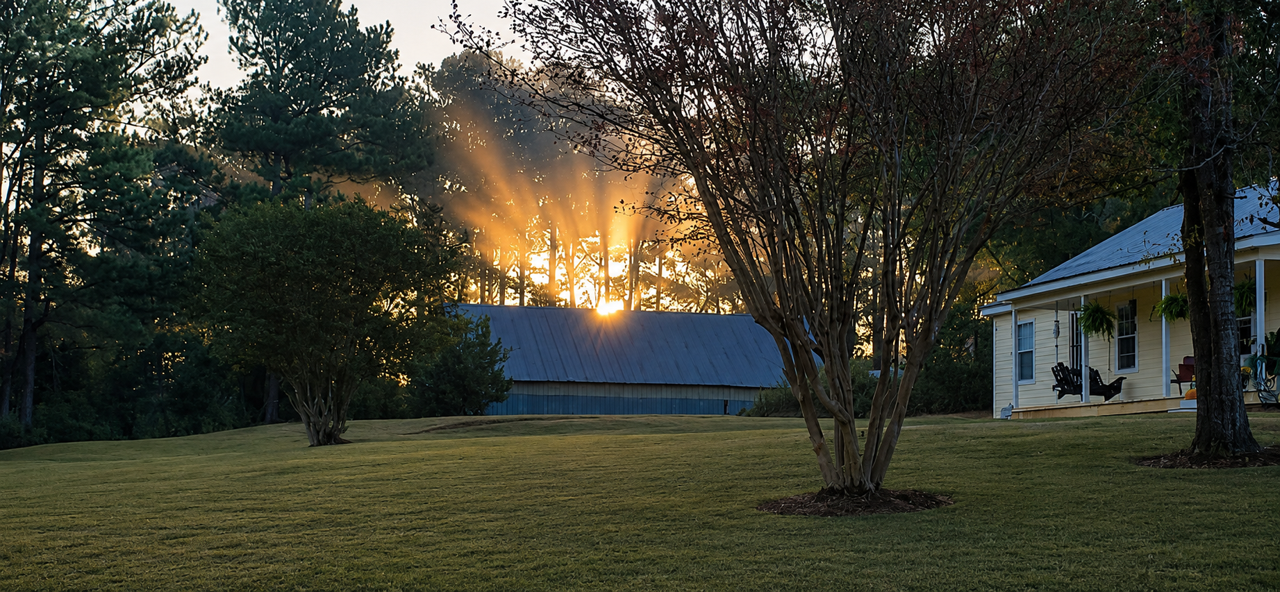 AI-enhanced sunset view illustrating a possible landscaped presentation of the main house and barn